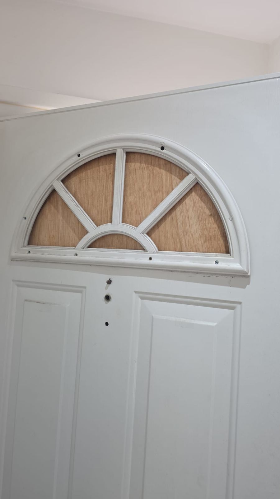 Arch fanlight window professionally boarded up by LT Lockworks London