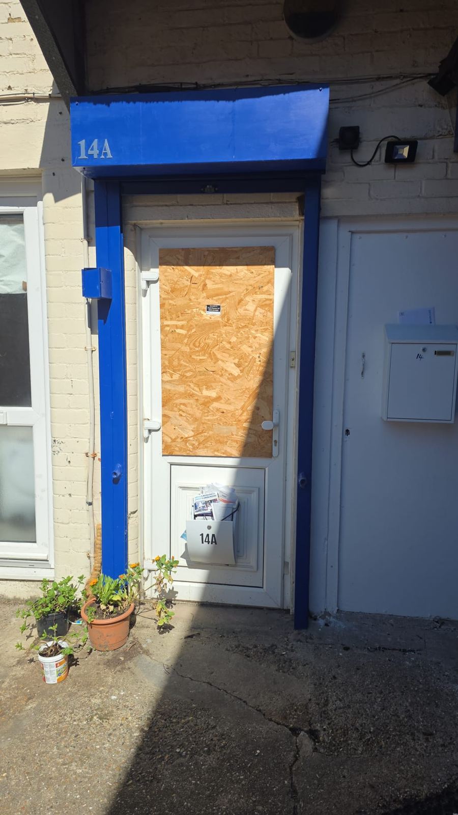 Commercial door fully boarded up with OSB board by LT Lockworks London
